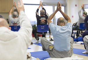 Veterans performing a gentle yoga stretch