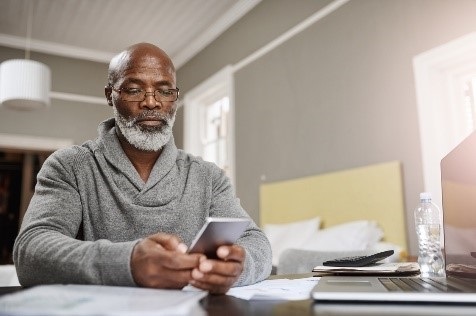 A Veteran reading a text from COVID Coach