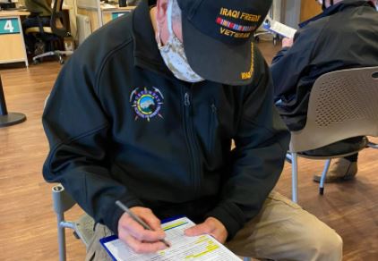 A male Veteran fills out paperwork