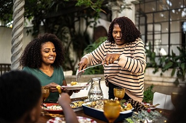 A Veteran and family enjoying a meal outside