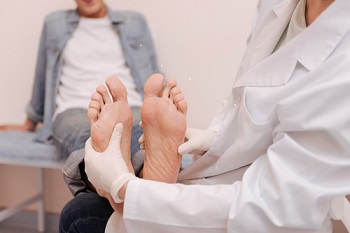 A Veteran getting his feet checked out by his doctor