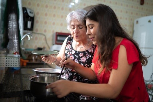 A Veteran making a healthy meal with her daughter