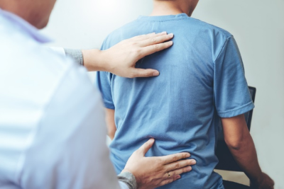 Doctor examining patient for tender points