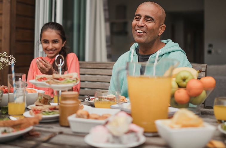 Family eating a healthy meal outside
