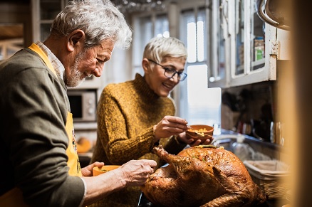 A Veteran and their partner preparing a holiday meal for their family