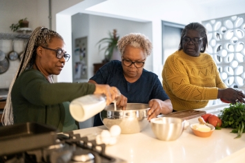 A Veteran and her family prepare a meal high in Vitamin D