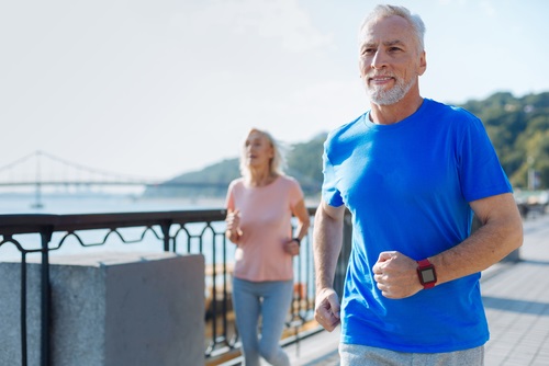 A Veteran and his partner running outside 