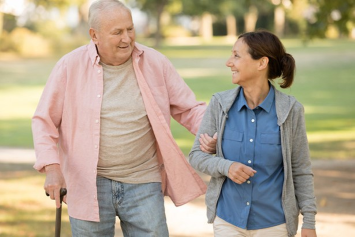 A Veteran and his companion walking outside arm in arm