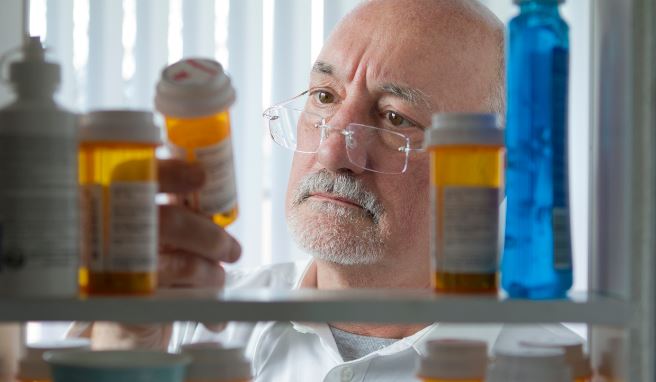 Veteran checking his medicine cabinet