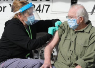 Man receives COVID-19 vaccine outside