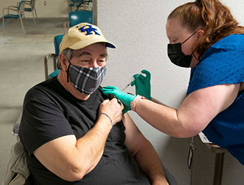A man receiving a COVID-19 vaccine at a clinic