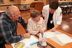 A couple looks over meal plans with dietitian