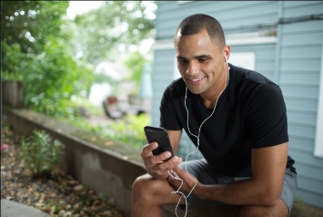 A Veteran checks their medical records on a smart phone.