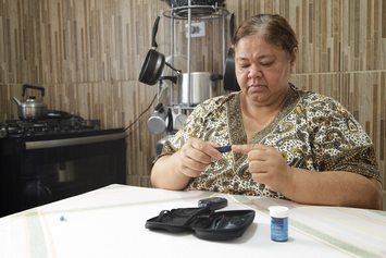 A Veteran checking her blood sugar