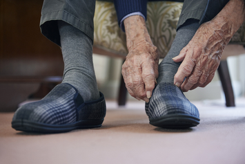 A Veteran protecting their feet with house slippers