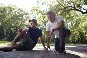 Two Veterans stretching and warming up in a park before a workout