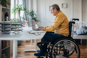 A Veteran accessing his VA medical report online with his laptop