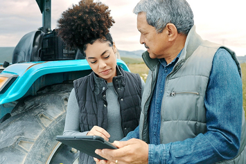 A Veteran and his daughter using a VA provided tablet in the field