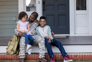 A Veteran returned from duty greeting his children 