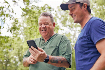 A Veteran uses his mobile device to check into his appointment