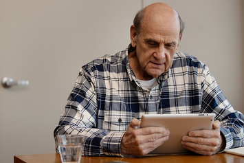 A Veteran watching a Facebook Live event on a tablet