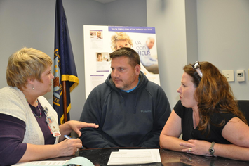 A Veteran couple talking to a VA social worker in her office