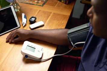 A Veteran taking his blood pressure at home 