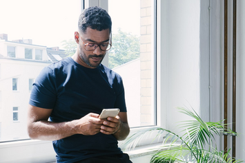 A Veteran reading his VA text message appointment reminder